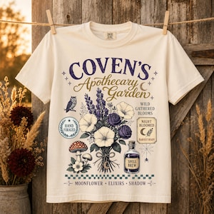 Vintage autumn shirt design featuring Retro Witch Herb Garden PNG with herbal magic illustration, floral bouquet, spell bottle, mushrooms, botanical clipart, and trendy witchy aesthetic.
