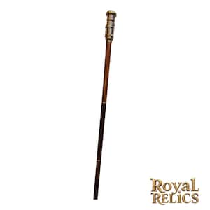 May include: A vintage walking cane with a dark brown wooden shaft and a decorative metal handle. The handle has a detailed, antique design with a gold finish. The lower portion of the cane is a darker shade of brown. The cane is approximately 36 inches in length.