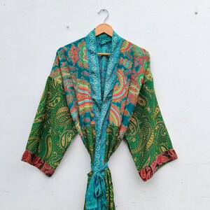 May include: A long-sleeved kimono robe featuring a vibrant green base with intricate multi-colored paisley patterns in shades of teal, orange, and pink. The garment includes a matching tie belt and a contrasting teal border along the front opening.