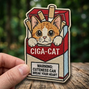 May include: Embroidered patch featuring a cartoon cat peeking out of a cigarette pack. The patch is red, tan, and blue with the text "CIGA-CAT" and "WARNING: CUTENESS CAN BREAK YOUR HEART."
