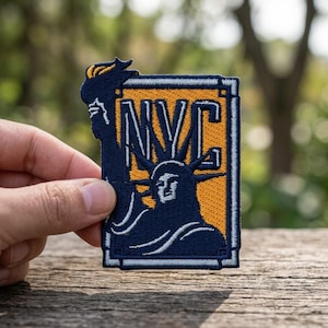 May include: A white ceramic mug with a black handle and the text "But First, Coffee" in a bold, black font. The mug is set against a blurred background, highlighting its clean design.