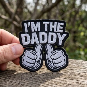 May include: A white ceramic mug with a black handle and the text "But First, Coffee" in a black, bold font. The mug is sitting on a wooden surface. The mug is approximately 4 inches tall.