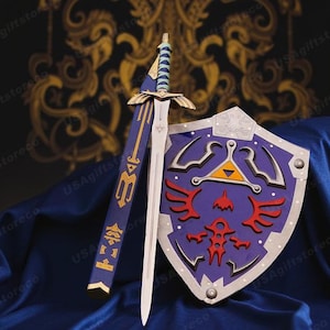 May include: A sword and shield set with a blue and gold hilt and scabbard. The shield is purple with red and yellow accents. The set is displayed on a blue surface.