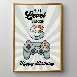 Könnte beinhalten: Ein gerahmtes Poster mit hellblau-weißem Strahlenhintergrund. Der Text lautet NEXT LEVEL UNLOCKED, Happy Birthday, und eine große 6 ist mit einem 50-Euro-Banknotenmuster gefüllt. Ein grauer Videospiel-Controller ist unter der Zahl zentriert.