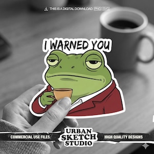 May include: A sticker featuring a green frog in a red blazer holding a cup of coffee, with the text "I WARNED YOU". The sticker also includes the text "URBAN SKETCH STUDIO" and "HIGH QUALITY DESIGNS".