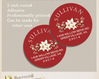 May include: Two round, 2 inch adhesive return address labels in deep red with white text and a central white floral illustration. The labels feature the name SULLIVAN and the address 1406 WILLOW BEND RD, GREER VILLAGE, VA 23014 printed in white.