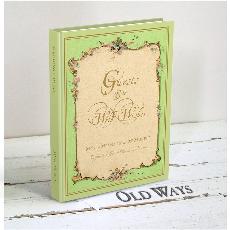 May include: A green and gold wedding guest book with the text "Guests & Well Wishes" and "MR. & MRS. NATHAN MCMURPHY" on the front cover. The book is titled "Wedding Guests" and the date "June 18, 2019" is printed on the spine.