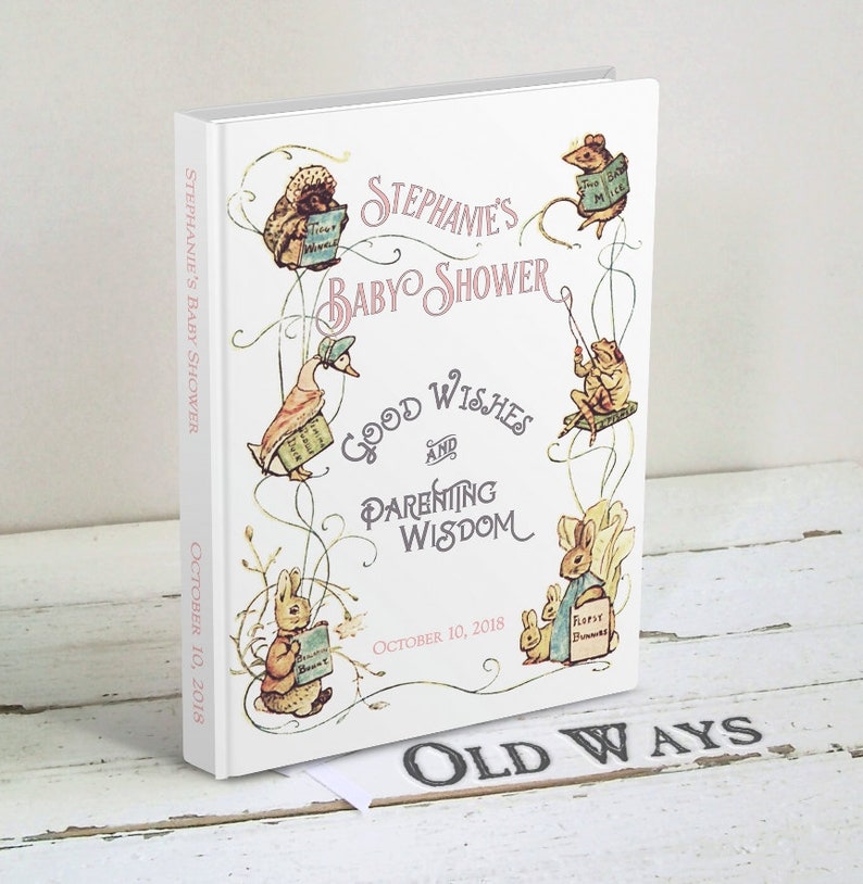 Puede incluir: Un libro blanco con un t&iacute;tulo rosa y negro que dice "Stephanie's Baby Shower Good Wishes and Parenting Wisdom" con una fecha del 10 de octubre de 2018. La portada del libro presenta ilustraciones de animales del libro "El cuento de Peter Rabbit" incluyendo Peter Rabbit, Jemima Puddle-Duck, Mrs. Tiggy-Winkle y los dos ratones malos.