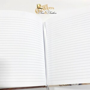May include: An open notebook with lined pages. The notebook has a brown cover and the text "Days & Feathers" is printed on the cover.