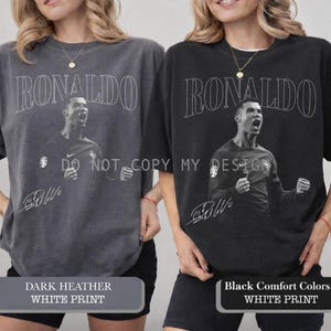 May include: Two oversized crewneck sweatshirts, one dark heather gray and one black, each featuring a white graphic of Cristiano Ronaldo and his signature. The word "RONALDO" is printed above the image.