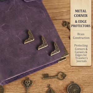 May include: A close-up of a purple leather journal with decorative brass corner protectors. The image also shows brass keys and a compass charm. Text on a wooden sign reads "METAL CORNER & EDGE PROTECTORS" and "Protecting Corners & Edges for Traveler's Journals."