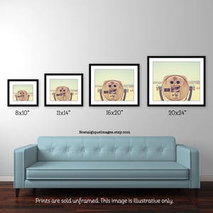 May include: A vintage photograph of a seaside viewfinder with a beach scene in the background. The viewfinder is a wooden structure with a lens on the front. The photo is available in four sizes: 8x10 inches, 11x14 inches, 16x20 inches, and 20x24 inches.