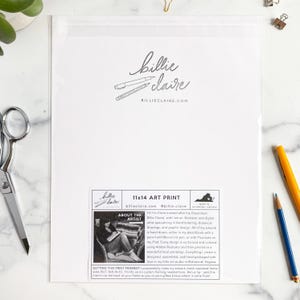 May include: An 11x14 art print in a clear plastic sleeve. The print features the artist's signature and website, along with text describing the artist's process. A pencil and pen are visible.