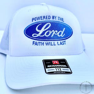 May include: White trucker hat with a curved brim and mesh back. The front features a blue oval design with the words "POWERED BY THE Lord FAITH WILL LAST". Includes a Richardson 112 Trucker tag.