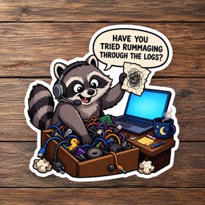 May include: A sticker featuring a cartoon raccoon wearing a headset, holding a piece of paper with scribbles, and sitting at a desk with a laptop, a mug, and a drawer overflowing with tangled electronic cables and a small yellow rubber duck.