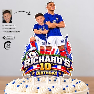 May include: A custom cake topper featuring a football player and a child in blue and white French football kits, standing on a football. The design includes the text RICHARD'S 10TH BIRTHDAY, a graphic of the Eiffel Tower, and red, white, and blue accents.