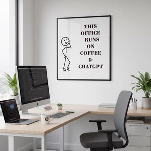 May include: A modern office setup with a framed print that reads "THIS OFFICE RUNS ON COFFEE & CHATGPT." The image includes a computer, laptop, mug, and a gray office chair. The desk is made of light wood.