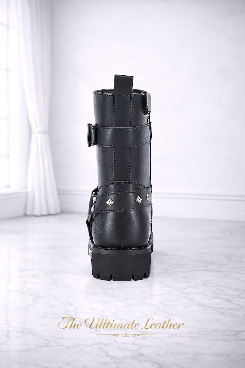 May include: Black leather boot with multiple straps, buckles, and decorative studs. The boot has a chunky sole and a mid-calf height. The text "The Ultimate Leather" is at the bottom of the image.