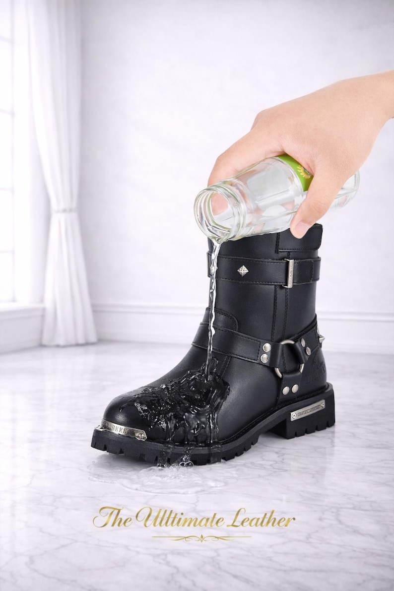 May include: Black leather boot with silver hardware, including buckles, rings, and studs. Water is poured onto the boot, demonstrating its waterproof feature. The text "The Ultimate Leather" is at the bottom.
