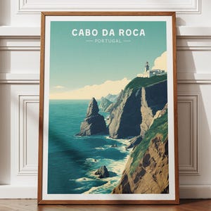 May include: A framed art print displaying a coastal scene with the text "CABO DA ROCA PORTUGAL". The image shows a lighthouse atop a cliff, with the sea and rock formations in blue and green hues. The frame is a warm brown colour.