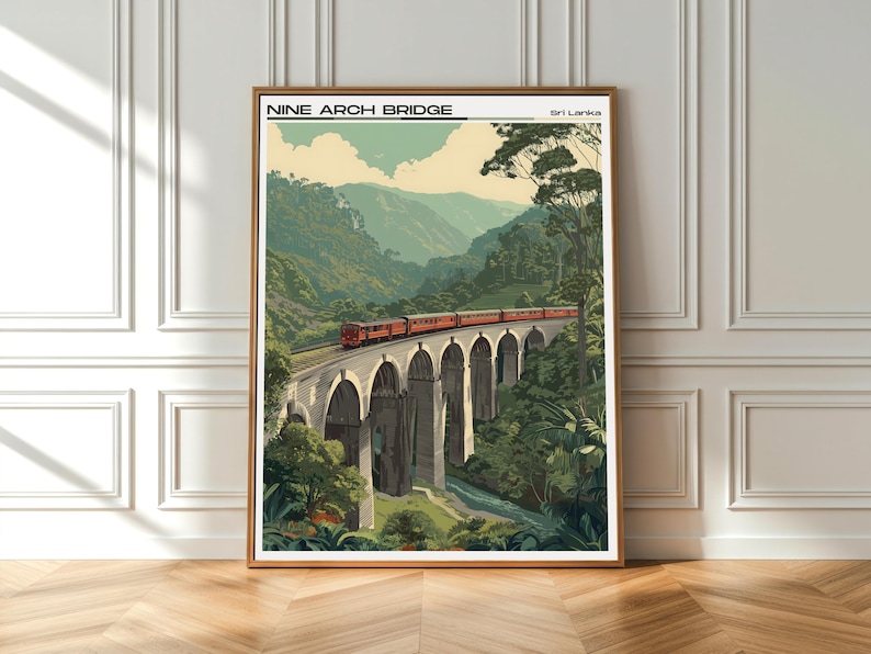 May include: A framed print of the Nine Arch Bridge in Sri Lanka. The image shows a red train on the bridge, set against a backdrop of green hills and trees. The text "NINE ARCH BRIDGE" is displayed at the top.