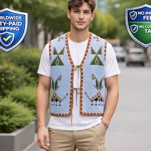 May include: A light blue knitted vest with geometric patterns in green and brown. The vest has a brown trim and a tie-up closure. The person is wearing a white t-shirt and khaki pants. The vest is a unique piece of clothing.