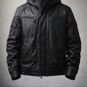 May include: A black hooded jacket featuring a front zipper closure, two vertical zippered chest pockets, and additional zippered utility pockets on each sleeve. The garment includes ribbed cuffs and a ribbed hem, constructed with a smooth finish.