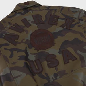 May include: A white ceramic mug with a black handle and the text "But First, Coffee" in a black, bold font. The mug is on a white surface. The mug is approximately 4 inches tall.