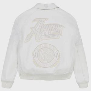 May include: White bomber jacket with the "Avirex New York" logo embroidered on the back. The jacket features a ribbed collar, cuffs, and hem, with mesh detailing on the sleeves. A circular emblem is also embroidered on the back.