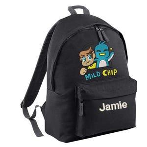 May include: A black backpack featuring an embroidered graphic of a cartoon character and a blue bird above the text Mild Chip. The front pocket displays the name Jamie in white embroidery. The bag includes a top handle and adjustable shoulder straps.