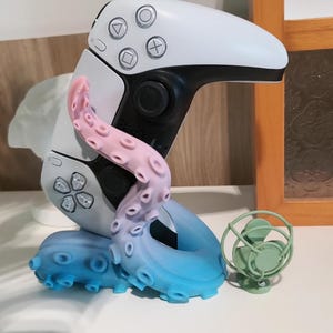 May include: A set of three ceramic mugs with a speckled, matte finish. Each mug features a different color: light blue, cream, and gray. The mugs have a simple, modern design with a rounded shape and a comfortable handle.