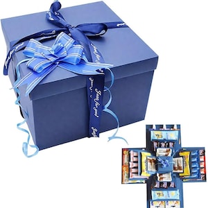May include: A navy blue gift box tied with a matching ribbon and bow. The ribbon is printed with the text "Just for you". Inside the box is a smaller box filled with wrapped sweets and chocolates.