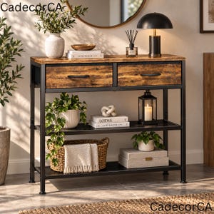 May include: A rectangular console table with a black metal frame and two drawers featuring a rustic brown wood grain finish. The unit includes two lower shelves holding a woven basket with a white throw, books, a lantern, and potted plants.