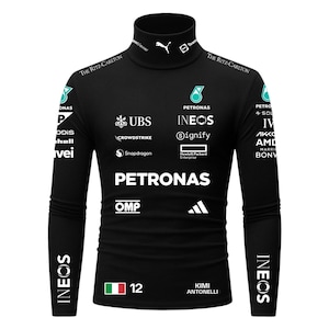 May include: Black long-sleeved turtleneck shirt with sponsor logos, including Petronas, Ineos, and UBS. The shirt features the text "Kimi Antonelli" and the number 12, along with the Italian flag. The design is likely for a racing team.
