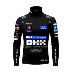 May include: A black long-sleeve turtleneck shirt featuring various sponsor logos including Dell Technologies, OKX, Hilton, Cisco, and Richard Mille. The shirt displays the Android logo, a small British flag, and the text LM1 on the lower front section.
