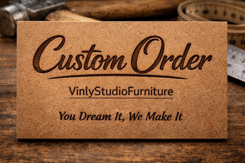 May include: A rectangular light brown wooden sign with dark brown laser-engraved text. The sign features the words Custom Order in a large script font, followed by VinlyStudioFurniture and the phrase You Dream It, We Make It in a standard font.