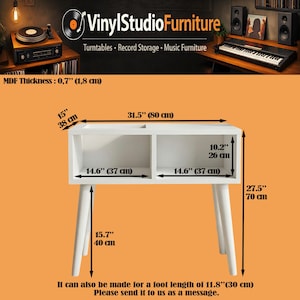 May include: A white record storage console with two open compartments and four tapered legs. Dimensions include a 31.5 inch width, 15 inch depth, and 27.5 inch height. The MDF thickness is 0.7 inches. Features include 14.6 inch wide compartments.