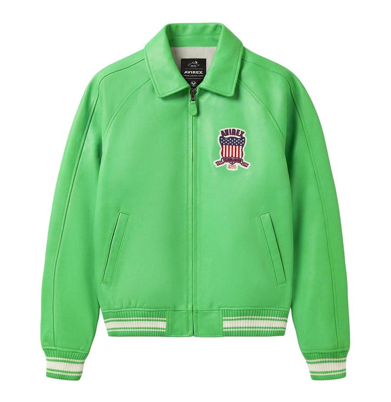 May include: Bright green leather jacket with a collared neckline and a zipper closure. Features a patch with an American flag design and the brand name. The cuffs and hem have white and green striped detailing.