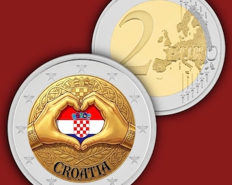 May include: A two-euro coin featuring a bimetallic design with a silver outer ring and a gold centre. The reverse shows a map of Europe and the number 2. The obverse displays two hands forming a heart shape over the Croatian flag and the text CROATIA.