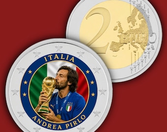 May include: A commemorative two-euro coin featuring a portrait of Andrea Pirlo kissing the FIFA World Cup trophy against an Italian flag background. The coin is encircled by stars and the text ITALIA and ANDREA PIRLO. The reverse shows the map of Europe.