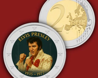 May include: Two Euro coins featuring Elvis Presley. One coin shows Elvis in a white suit with red accents, holding a microphone. The text "ELVIS PRESLEY 1935-1977" is displayed. The other coin shows the number "2" and a map of Europe.