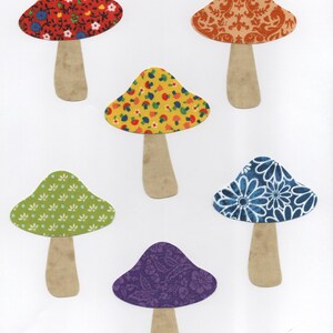 May include: A collection of six colorful mushroom cutouts. Each mushroom has a beige stem and a patterned cap in various colors, including red, orange, yellow, green, blue, and purple. The patterns include floral and paisley designs.