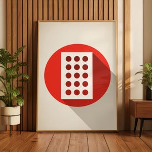 May include: A framed art print featuring a white rectangle with 15 red circles, set against a large red circle. The artwork is displayed on a white background with a long shadow, framed in a light wood frame.