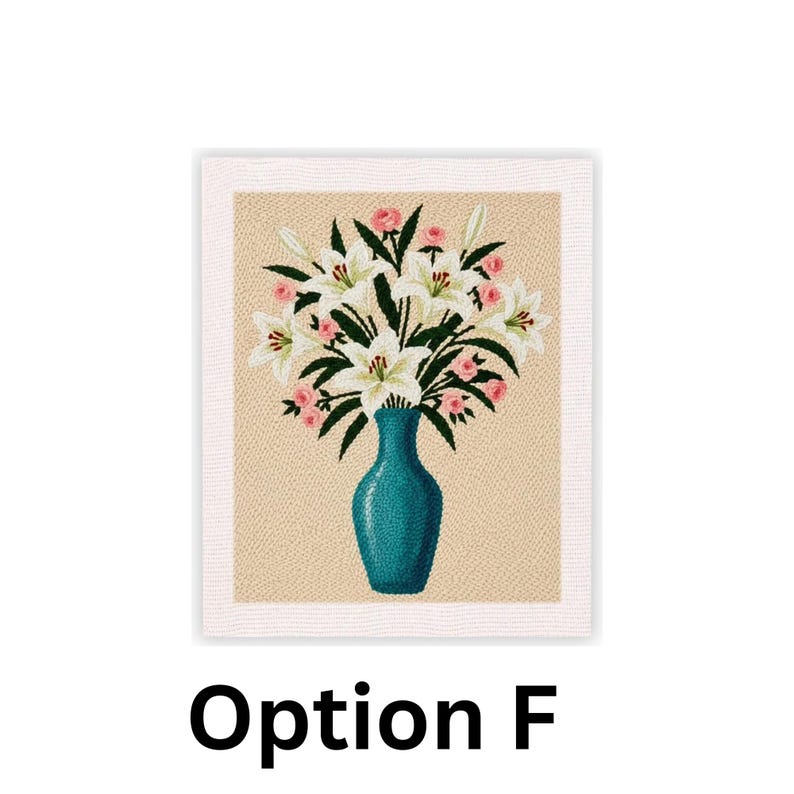 May include: A framed floral needlepoint featuring a teal vase filled with white lilies and pink roses. The background is a light tan color, and the frame is white. The text "Option F" is at the bottom.
