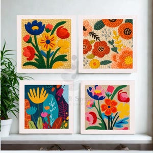 May include: Four framed floral art pieces. Each square features a different colourful flower arrangement, including red, yellow, blue, and orange blooms. The artwork is set against a neutral background, with a white frame.