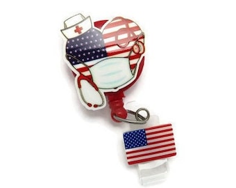 May include: Red retractable badge holder featuring a design of a nurse wearing a face mask and a stethoscope, with an American flag design. The holder has a small American flag attached to it.