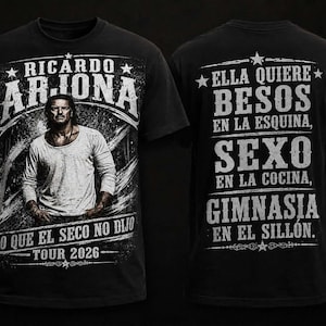 Puede incluir: Camiseta negra con un retrato de Ricardo Arjona y el texto "Ricardo Arjona Tour 2026". La parte trasera de la camiseta muestra texto en español, incluyendo "Ella Quiere Besos" y "Sexo".