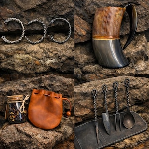 May include: Three silver-toned twisted metal bracelets with wolf head terminals, a polished horn drinking mug, a small brown leather drawstring pouch with a glass jar of dried herbs, and a set of four forged metal utensils on a leather roll.