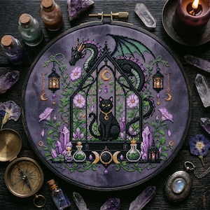 magical fantasy cross-stitch pattern featuring a black cat sitting inside a gothic greenhouse while a dark dragon with green wings curls protectively around the roof. The scene is decorated with lavender flowers, leafy vines, purple crystals, potion bottles, hanging lanterns, crescent moon charms, and celestial ornaments. The rich palette of black, green, lavender, gray, purple, and gold creates a mystical witchy garden mood, perfect for cat lovers, dragon fans, fantasy décor, and handmade walL