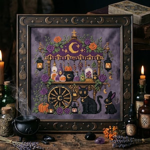 May include: A framed cross-stitch embroidery featuring a purple background with a detailed apothecary cart scene. The design includes a black cat, a black rabbit, pumpkins, potion bottles, lanterns, and floral accents, all enclosed in a dark frame.